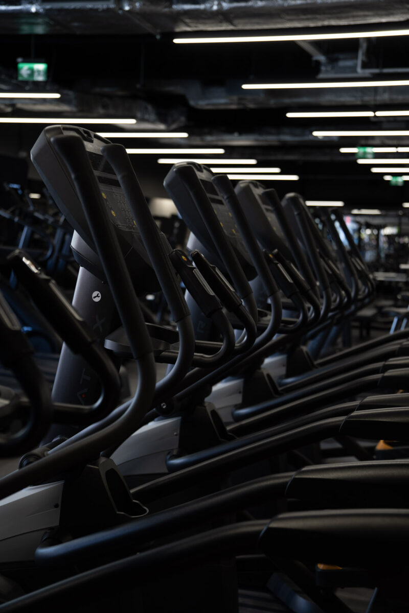 A row of professional elliptical machines (orbitrains) by Matrix, set in a modern cardio area.